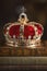 A Gold Coronation Crown with Red Velevet on a Stack of Old Books