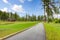 Gold course trail with pine trees and homes.