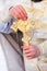 Gold cross in the hands of a priest close-up. Time to consecrate the water