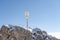 Gold cross at top of Zugspitze coverd in snow in summer morning