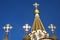 Gold crosses on the dome on the blue sky background on the Church of the Resurrection in Sokolniki, Moscow, Russia.