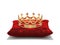 Gold crown on red velvet pillow