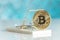 Gold cryptocurrency coin bitcoin in mousetrap on green background. Crypto currency financial trap concept.