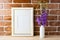 Gold decorated frame mockup with bellflower bouquet exposed brick wall