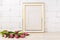 Gold decorated frame mockup with magenta tulips bouquet