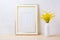 Gold decorated frame mockup with ornamental yellow flowering grass in vase