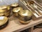 Gold decorative deep bowls. Empty metal bowls on a shelf in a store