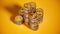 Gold Dollar coins stack, golden coin heap on yellow background.