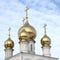 Gold domes of the Russian Orthodox Church on the background of blue sky. Russia. Siberia