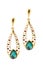 Gold earrings inlaid with  gemstones on a white background