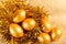 Gold eggs on a nest on a golden background