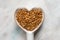 Gold Flaxseeds in a Heart Shape Spoon