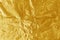 Gold foil leaf shiny texture, abstract yellow wrapping paper for background