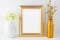 Gold frame mockup with golden vase and ivory hydrangea