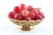Gold fruit dish with red grape