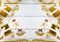 Gold gift boxes and glittering Christmas decorating items on white wood panel background, decoration item and copy space, top view