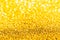 Gold glitter close-up background with shallow depth of field