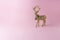 Gold glitter reindeer on pink background. Minimal New Year