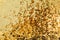 Gold glitter texture. Celebratory background. Golden explosion of confetti.