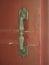 Gold handle on the red wooden door