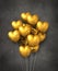 Gold heart shape air balloons group on a concrete background