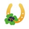 Gold horseshoe with four leaf clover. Lucky symbols.