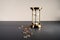 Gold hourglass and coins isolated on grey table. Saving and financing concept