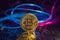 gold iron coin bitcoin on shiny silver background. blue and pink wire cyberpunk in future