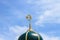 Gold islamic religious symbol on top of a mosque dome