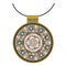 Gold jewelery mandala, decorated with turquoise and jasper on black background.