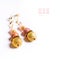 Gold jewerly earrings with semiprecious at white background