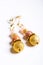 Gold jewerly earrings with semiprecious at white background