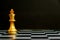 Gold king chess piece stand on black background with copy space