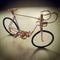 Gold little iron bike.