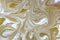 Gold marbling texture design. Beige and golden marble pattern. Fluid art. Dust, water.