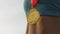 Gold medal shining in the sun, hanging on athlete\'s neck, victory and success