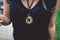 Gold medallion hanging on woman`s neck.