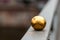 Gold Metallic Sphere On Railing