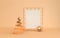 Gold metallic xmas tree, white paper on golden grid, xmas decorative star, pastel beige studio room. Shiny ribbon. Illustration f