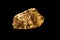 Gold nugget on black background.