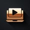 Gold Online play video icon isolated on black background. Laptop and film strip with play sign. Long shadow style