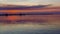 Gold orange sunset  at sea water reflection boat on horizon in harbor nature landscape background