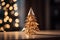 a gold origami christmas tree sits on a table