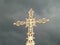 Gold ornate cross on dark sky