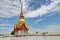 A gold pagoda stands out from the blue sky in central region of Thailand