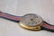 Gold plated old shabby soviet watch closeup on wooden table