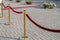 Gold plated rope barrier with red event carpet