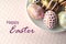 Gold polka dots and stripes on decorated Easter eggs on solid pastel color background