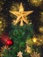 Gold, red and straw vintage decorations in the Scandinavian style on an artificial Christmas tree isolated on a black