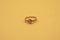 Gold ring on yellow background